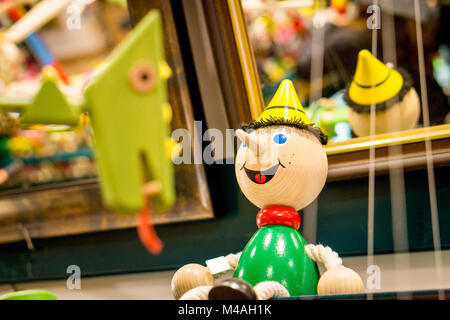 A wooden boy figure on a toy store shelf. Stock Photo
