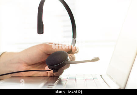 Help desk, support hotline or call center concept. Video call conference or telemarketing.  Customer service person holding headset. Stock Photo