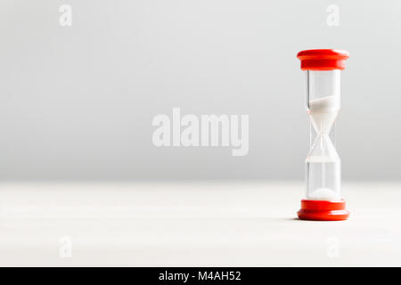 Sand in hourglass. Time passing concept with negative copy space. Stock Photo