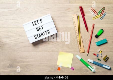 Let's get started writing in lightbox with pen, pencil, highlighter and ruler lying on office desk as flat lay Stock Photo