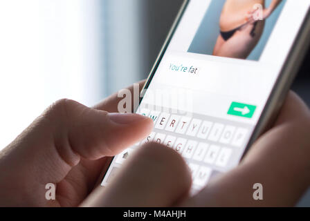 Body shame, cyber bullying and bad behavior online concept. Internet troll sending mean comment to picture on an imaginary social media website. Stock Photo