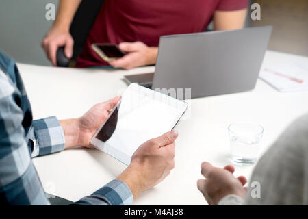 Small business, start up or marketing team working together and having meeting. Workstation with modern technology. Happy casual business people. Stock Photo