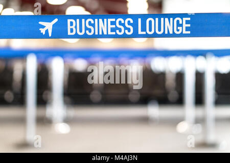 Business lounge at airport. Vip waiting area at terminal with seats in a row. Airport waiting room at terminal. Empty bench at gate. Stock Photo