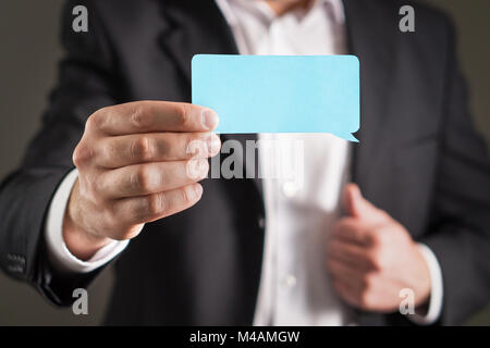 Business man holding speech bubble business card. Stock Photo