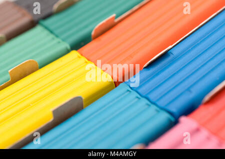 A box with a multi-colored plasticine of elongated shape Stock Photo