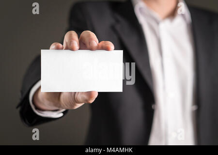 Business man holding empty white business card. Stock Photo