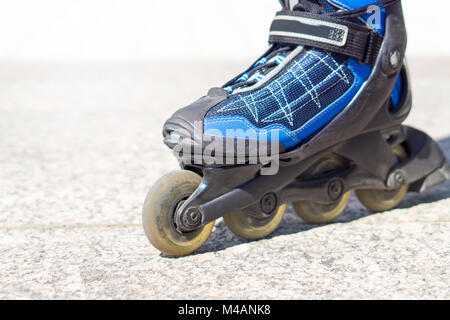 Close up to roller skate. Rollerskates and inline skates on tarmac and asphalt in the city. Stock Photo