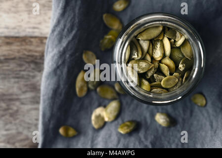 Pumpkin seeds in the glass jar top view Stock Photo