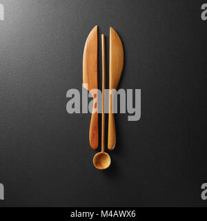 Top view of black alarm clock with wooden knife Stock Photo
