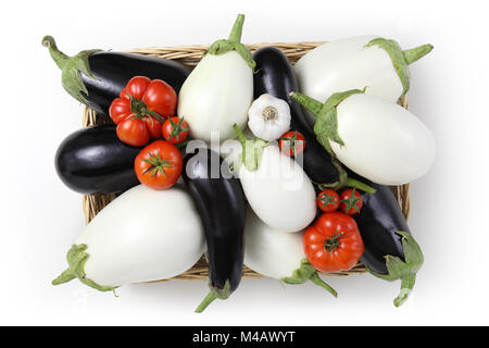 top view food white and black eggplants with tomatoes and garlic in basket isolated on white background Stock Photo