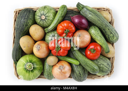 top view food zucchini with tomatoes, onion and potatoes in wicker, basket isolated on white background Stock Photo