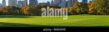 Panoramic view of Central Park South Sheep Meadow in early morning sunlight. Manhattan, New York City