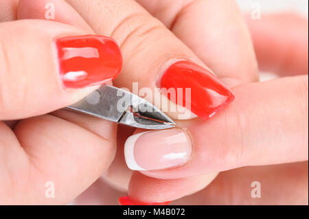 Cuticles cutting with nail clippers Stock Photo