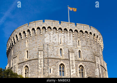 The Royal Standard flag flying on / from a flagpole / pole at Windsor Castle, UK. It is flown at royal residences only when the sovereign is present.