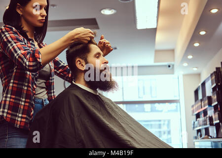 Handsome bearded man in the barbershop. Stock Photo