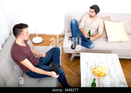 Two Friends having a conversation in the living room Stock Photo