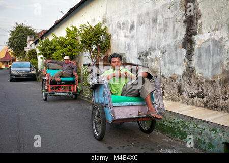 Becak drivers waiting for customers in Kampung Taman neighborhood. Yogyakarta, Java, Indonesia. Stock Photo