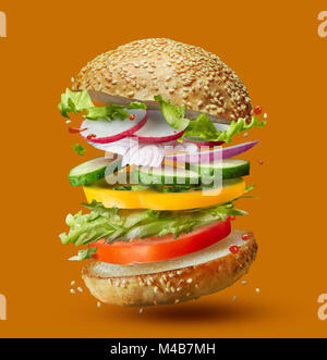 Burger preparation ingredients falling into place Stock Photo