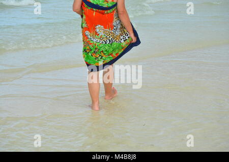 Active senior Caucasian woman on vacation walking on the beach on a tropical Caribbean island (Cayo Coco, Cuba) Stock Photo