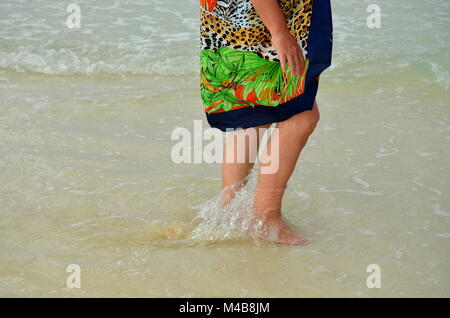 Active senior Caucasian woman on vacation walking on the beach on a tropical Caribbean island (Cayo Coco, Cuba) Stock Photo