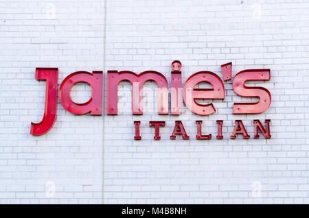 Sign for Jamie's Italian restaurant on white brick wall in the Bullring Shopping centre in Birmingham, UK Stock Photo