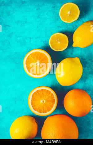 Lemons and oranges on the cyan background vertical Stock Photo
