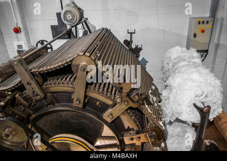 Carding machine that disentangles, cleans and intermixes fibres to produce a continuous web or sliver in cotton mill / spinning-mill Stock Photo