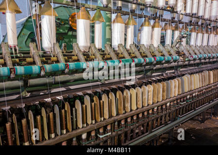 Spindles on ring spinning frame, machine for spinning fibres to make yarn in cotton mill / spinning-mill Stock Photo