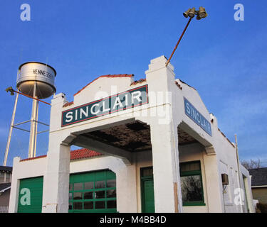 The Hennessy Oklahoma water tower stands behind the old Sinclair gas station on Highway 81. Stock Photo