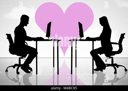 Silhouette Of Couple In Love Using Computers Stock Photo