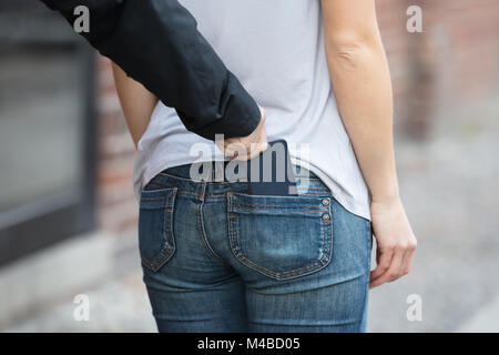 Thief Stealing Smartphone From woman's Jeans Pocket Stock Photo