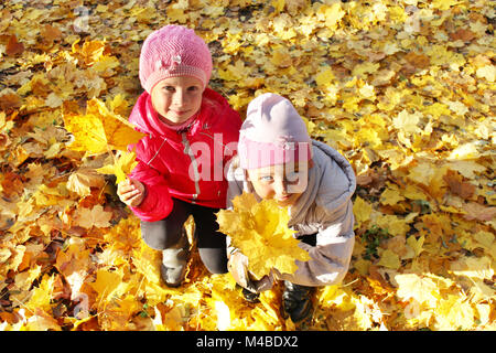 two little girls playing in the autumnal park Stock Photo