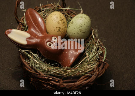 Chocolate Easter bunny in a basket Stock Photo