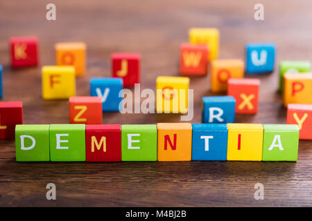 Dementia Text On Multi Colored Cubes On Wooden Table