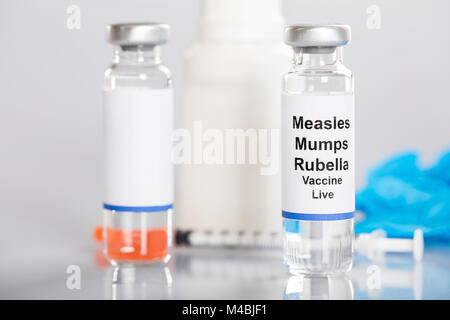 Close-up Of Measles Mumps Rubella Vaccine With Syringe And Medicines Stock Photo