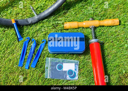 Flat tire of bicycle with repair material Stock Photo