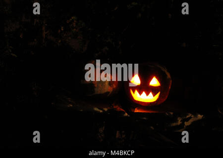 bright mask glowing on Halloween in the darkness Stock Photo