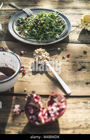 Green salad with pomegranate, manna croup, onion Stock Photo