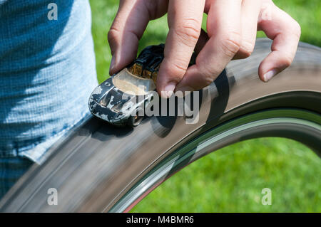 Boy plaing with car toy and bisycle vehicle Stock Photo