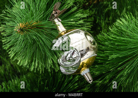 Broken Christmas toy on a Christmas tree background Stock Photo