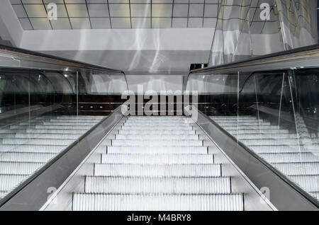 Empty escalator stairs moving up in modern office building Stock Photo