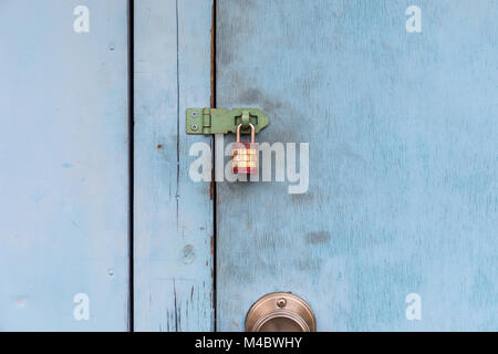 Padlock on blue door; Tokyo, Japan Stock Photo