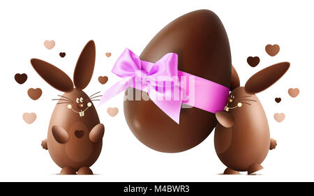 Chocolate Easter bunnies with egg and pink ribbon bow isolated on white background Stock Photo