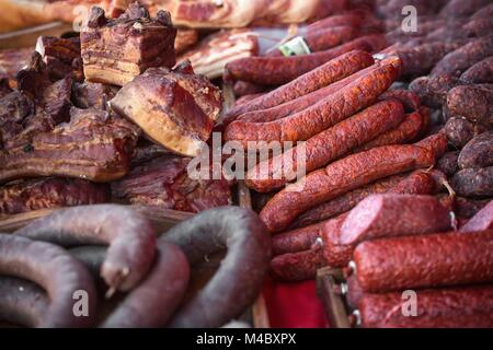 Sale of homemade sausages, salami and other meat products Stock Photo