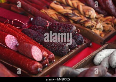 Sale of homemade sausages, salami and other meat products Stock Photo