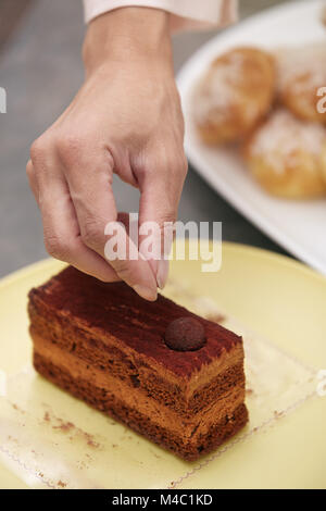 Woman confectioner preparing cake Stock Photo
