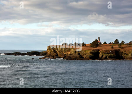 WA13439-00...WASHINGTON - The decommissioned Cape Flattery Light located off-shore on Tatoosh Island viewed from the Cape Flattery viewpoint in the Me Stock Photo