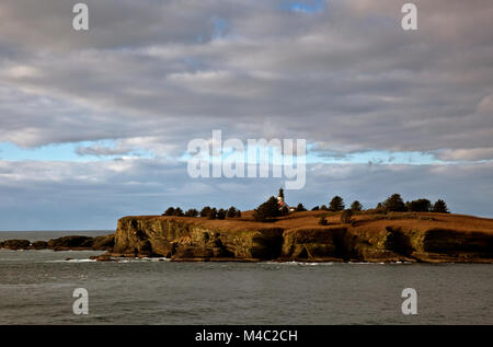 WA13440-00...WASHINGTON - The decommissioned Cape Flattery Light located off-shore on Tatoosh Island viewed from the Cape Flattery viewpoint in the Me Stock Photo