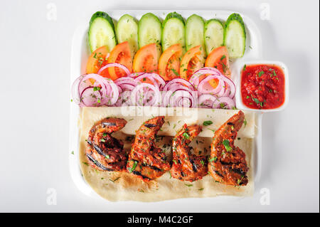 Grilled lamb tongues with fresh vegetables salad Stock Photo