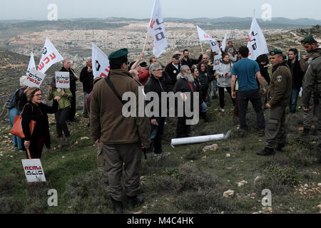 Nativ Ha'avot, Israel. 15th Feb, 2018. Members of the left-wing Peace Now movement taking part in a protest next to the illegal outpost of Nativ Ha'avot on following Israeli government attempts to postpone the removal of some of the houses in the outpost despite the Supreme Court ruling after accepting the petition of a group of Palestinians who argued the homes had been partially built illegally on their land. Credit: Eddie Gerald/Alamy Live News